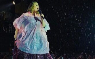 Adele mặc áo mưa hát ở sân vận động