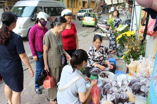 Khách thường mua rượu nếp để từ sáng sớm để đem dâng lên ông bà tổ tiên. Nhiều chủ hàng kiếm bộn tiền trong ngày hôm nay.